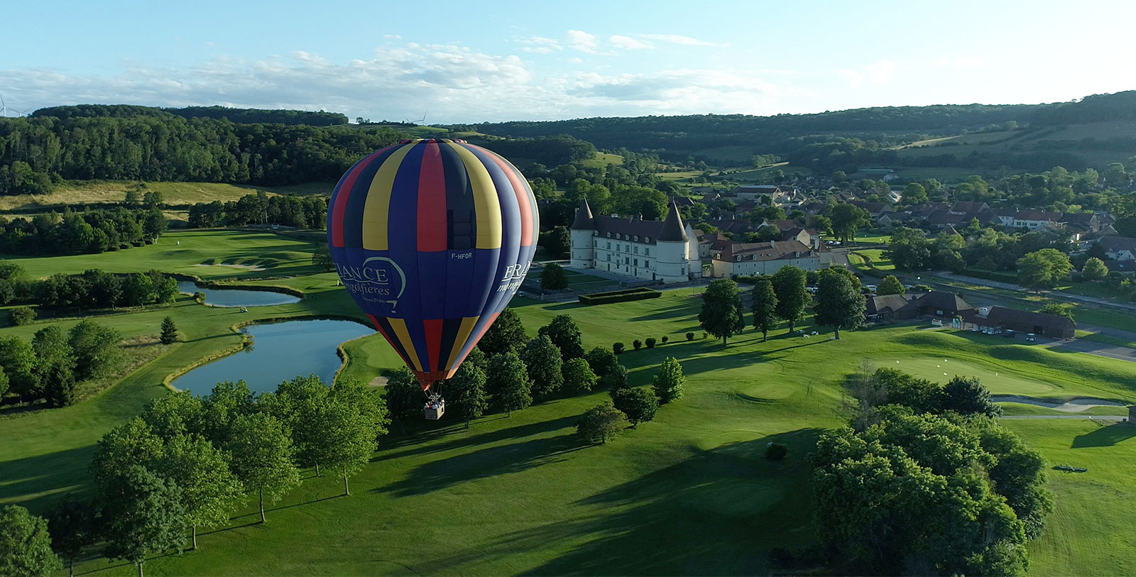 Image of hot air balloon floating above the grounds of Hôtel Golf Château de Chailly, 16th century, a member of Historic Hotels Worldwide in Chailly-sur-Armançon, Burgundy, France
